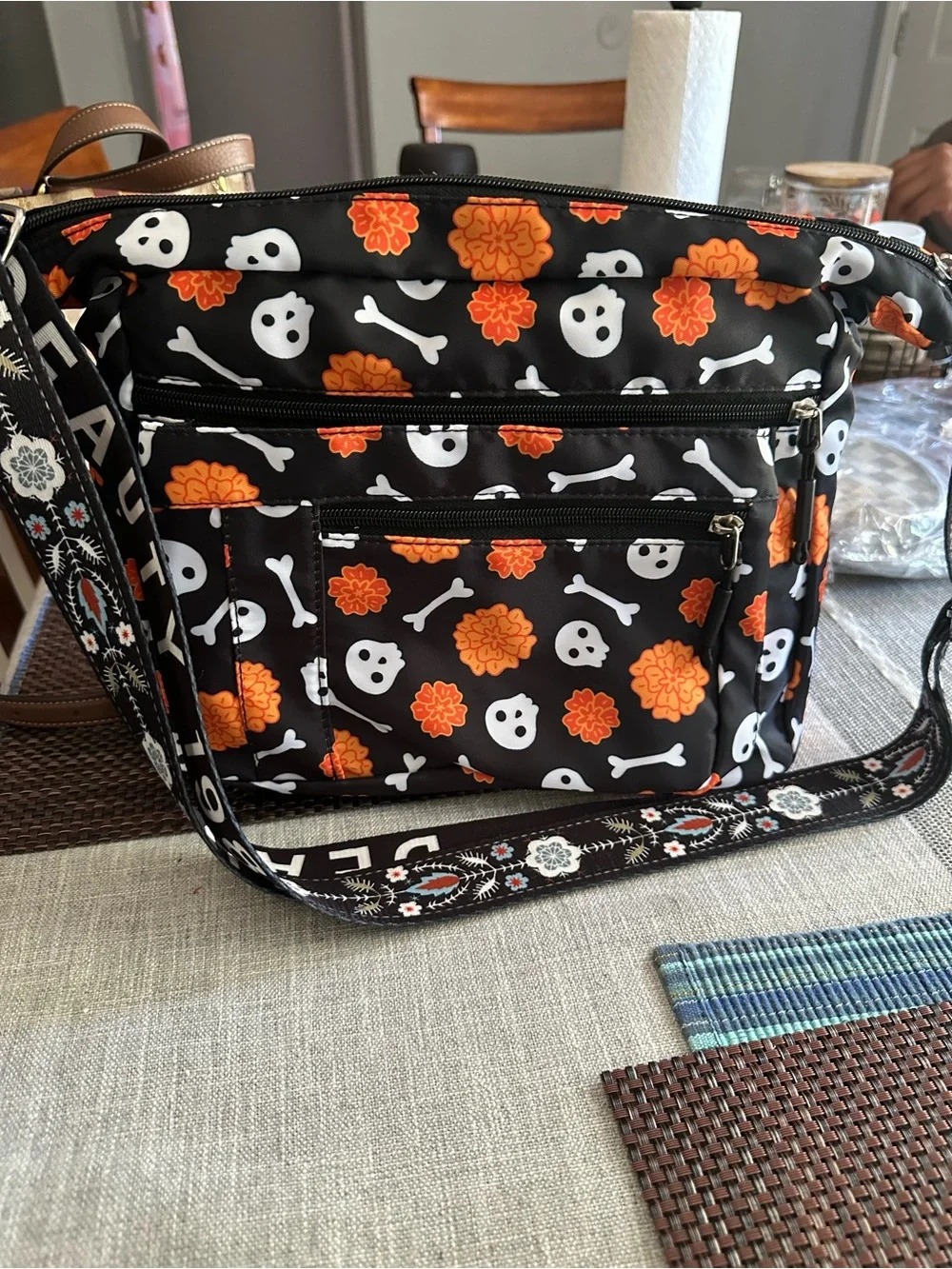 Halloween-themed crossbody bag featuring a skull and marigold print